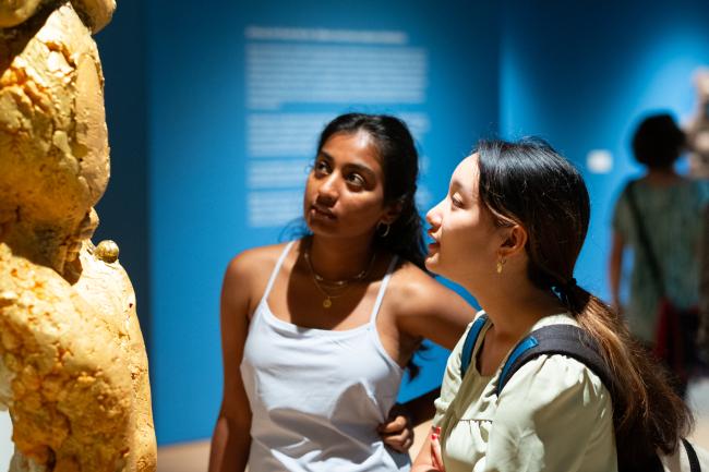 Students looking at Mother Mold sculpture by artists Coralina Rodriguez Meyer.